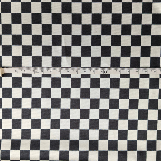 Black and white checkered fabric with a ruler for scale